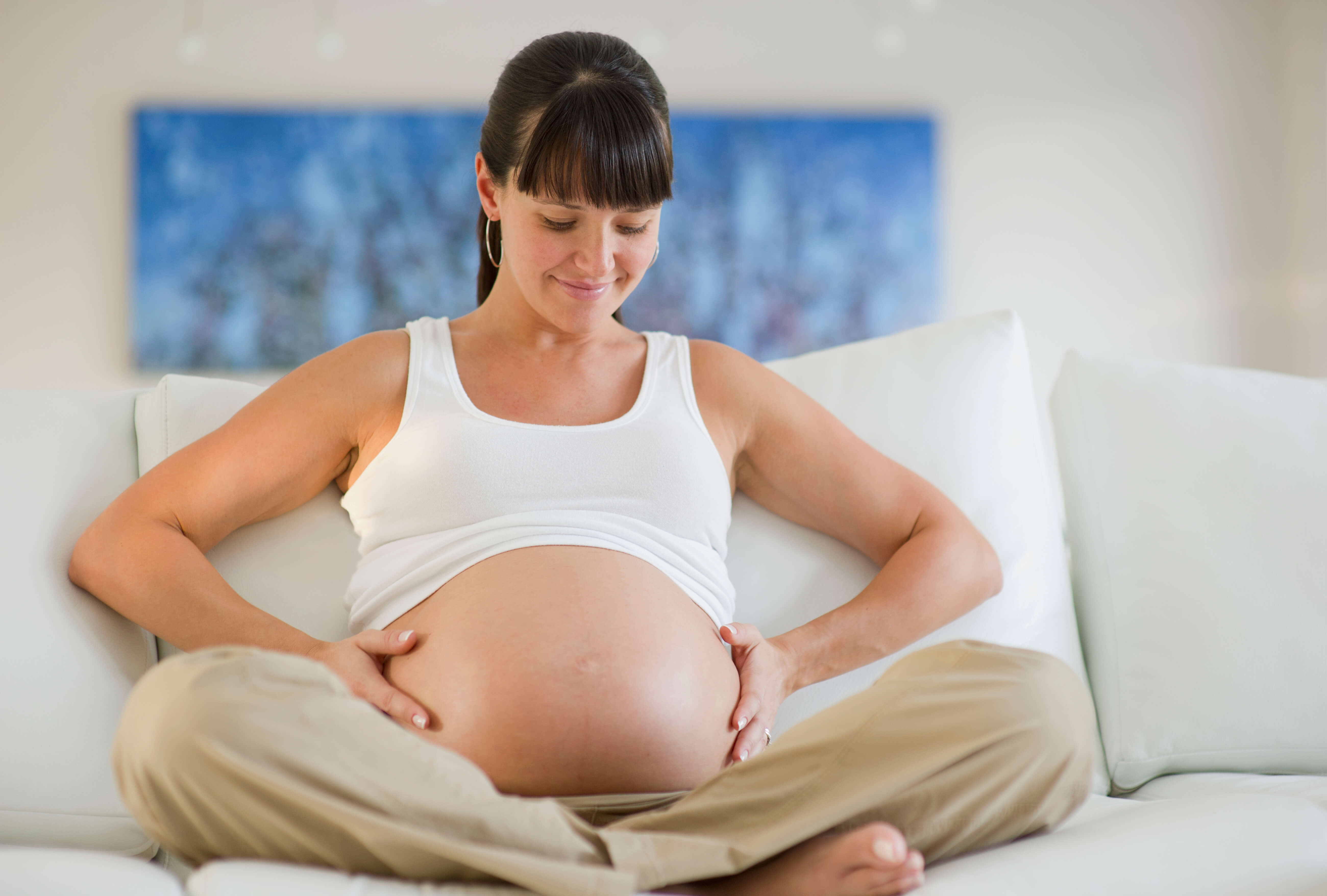 pregnant woman holding her stomach